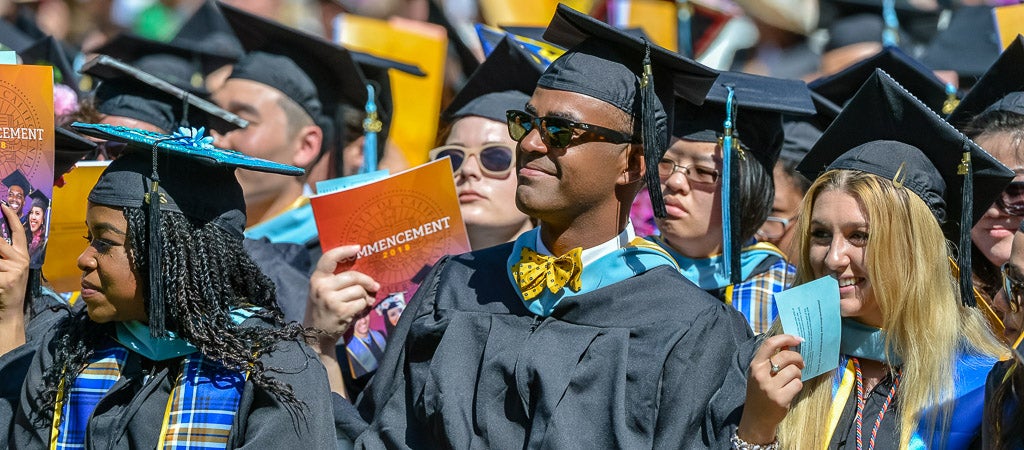 UCR students wear their caps and gowns during a commencement ceremony.